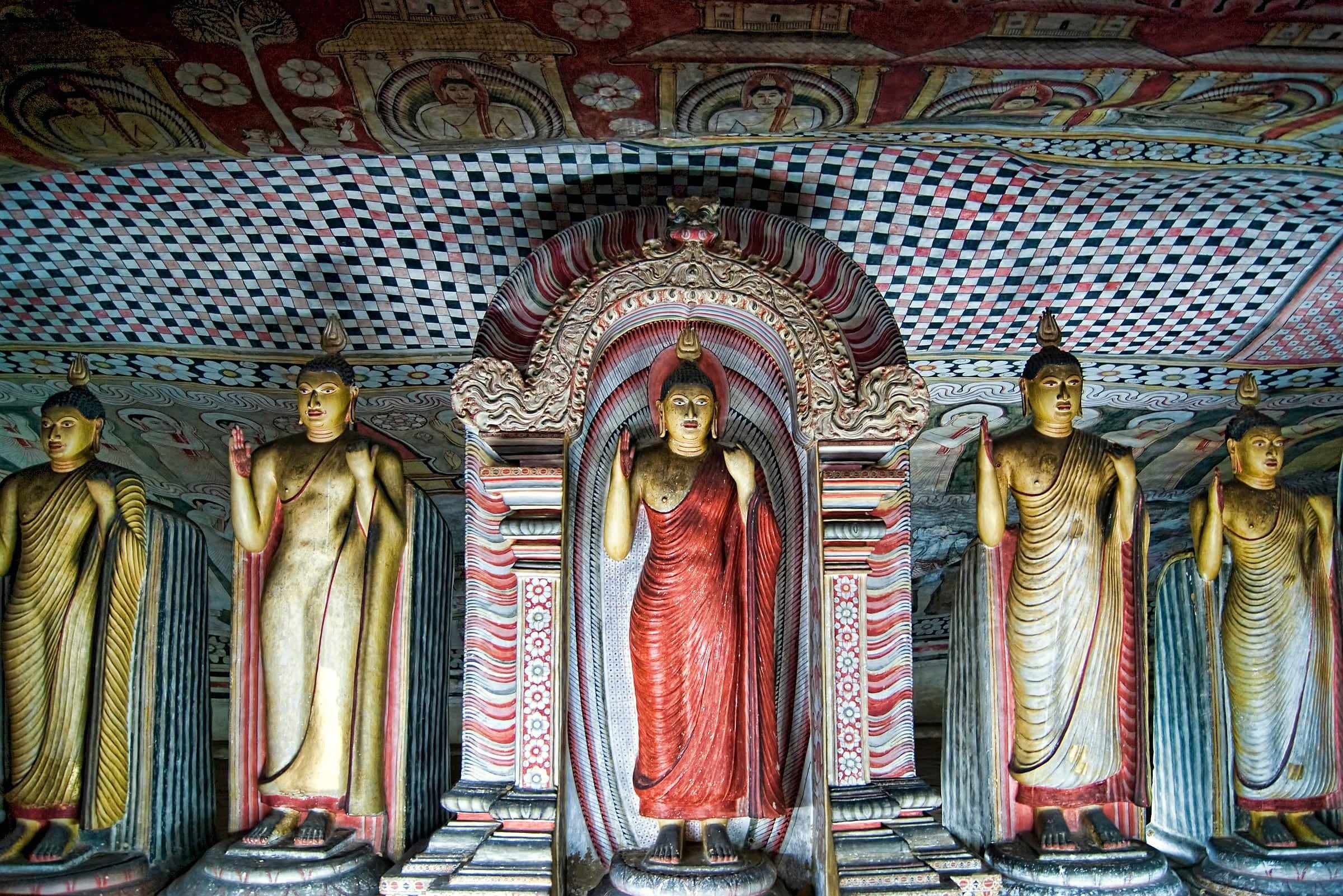 Painted ceiling and Buddha statues inside the Dambulla cave temple