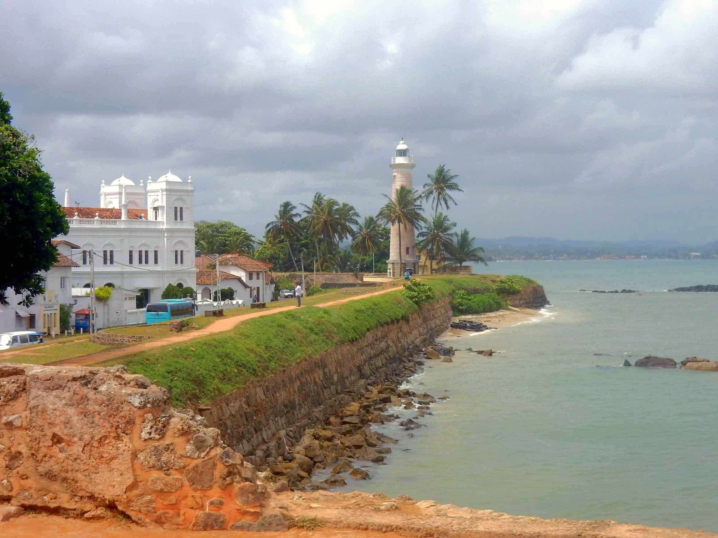 Galle Fort ramparts and lighthouse beside the sea