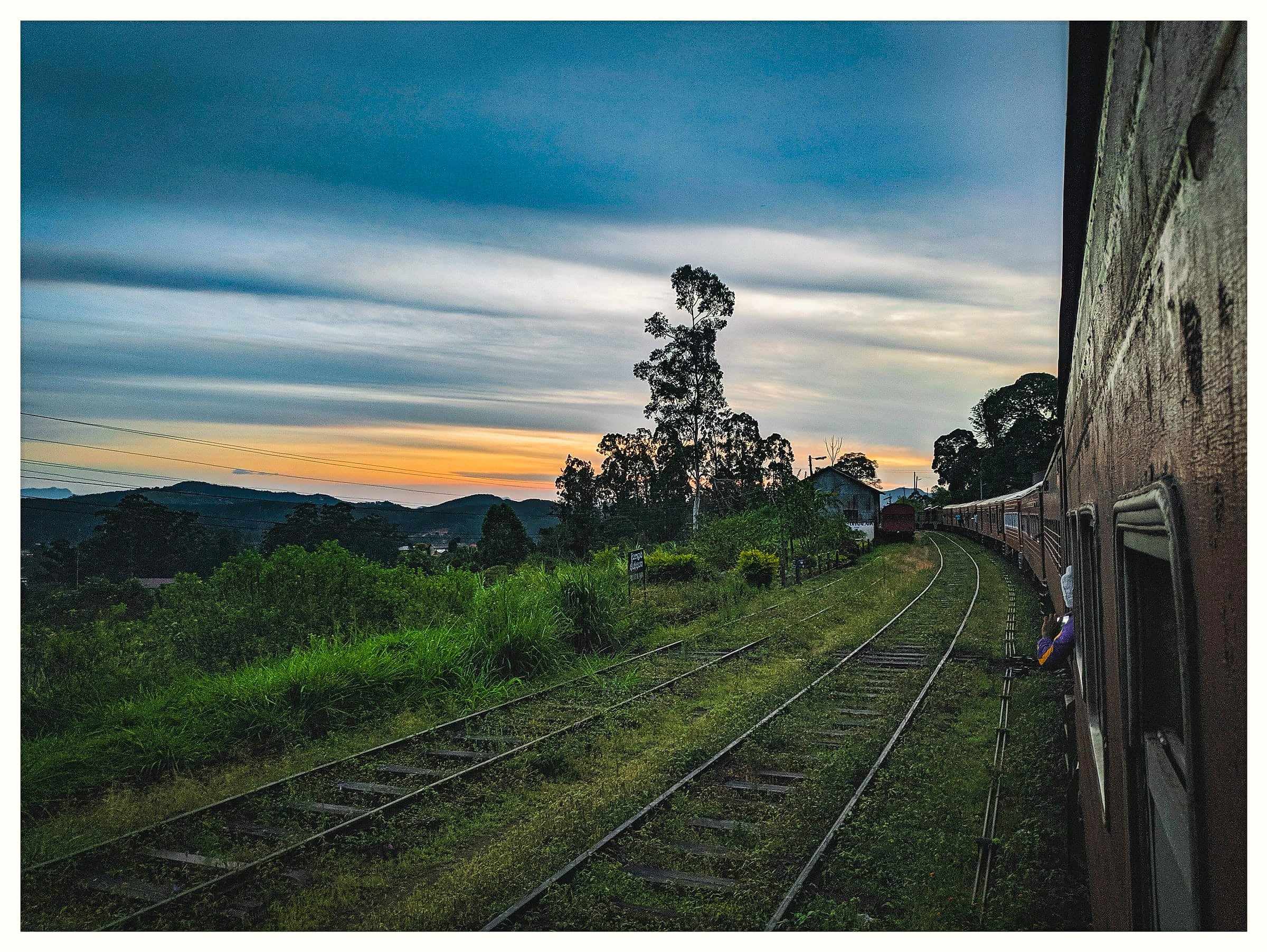 View along the railway tracks from a train in the hill country at dusk